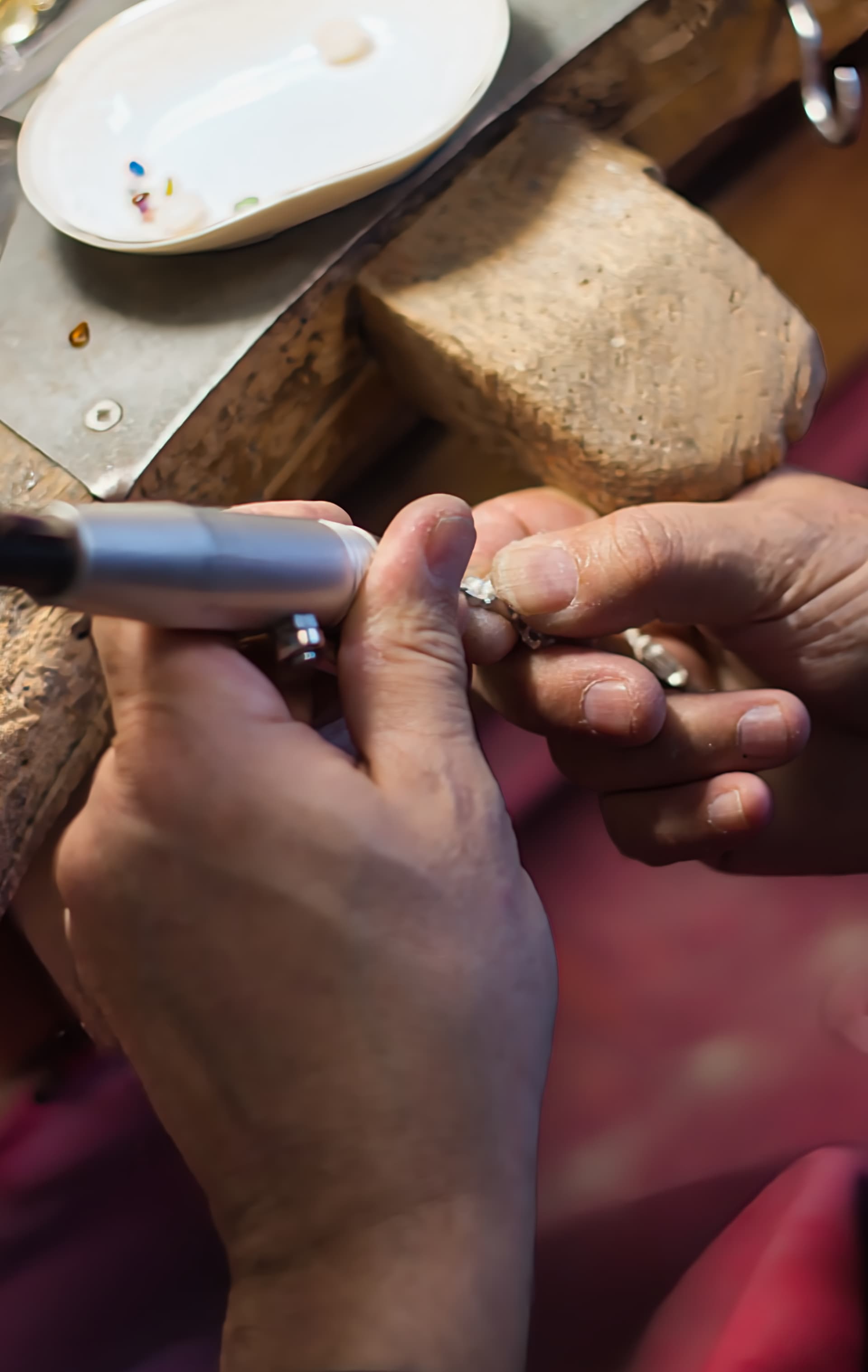 A hand-selected gemstone being set into a silver mount